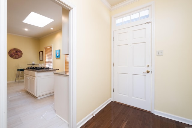 entryway with ornamental molding and light wood-type flooring