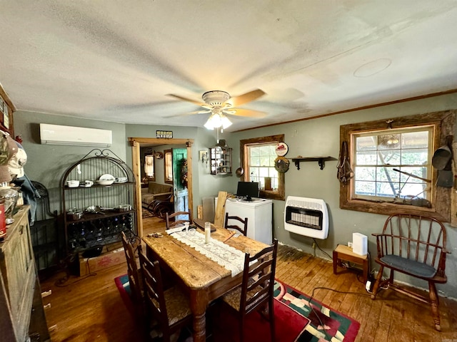 dining space with an AC wall unit, heating unit, a healthy amount of sunlight, and dark hardwood / wood-style flooring