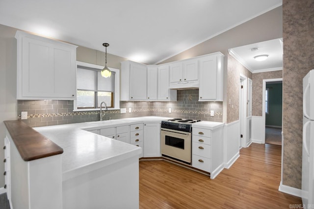 kitchen featuring sink, white range with gas stovetop, white cabinetry, vaulted ceiling, and light hardwood / wood-style flooring