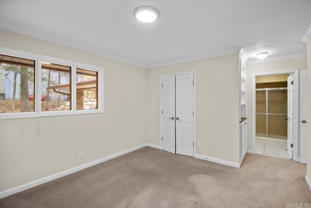 unfurnished bedroom with light carpet, a closet, and crown molding