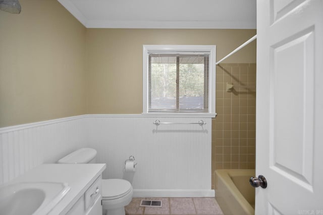 full bathroom featuring toilet, tile patterned flooring, tiled shower / bath, ornamental molding, and vanity