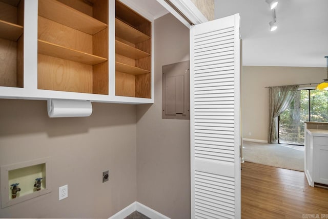 washroom with hookup for an electric dryer, hardwood / wood-style floors, electric panel, and washer hookup