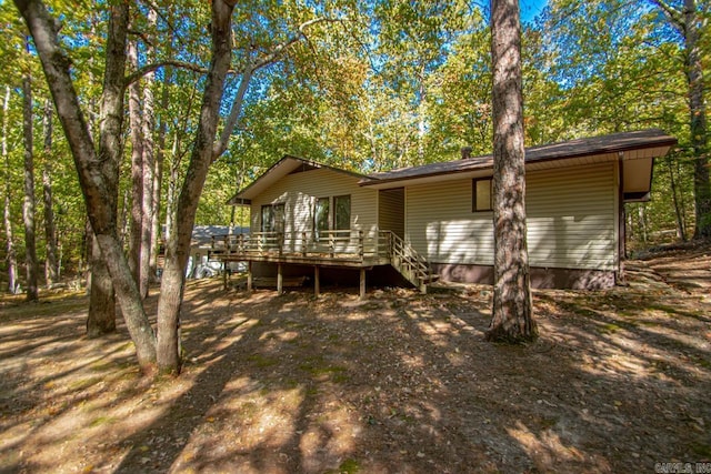 rear view of property featuring a deck