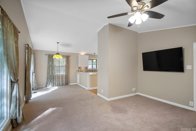 unfurnished living room with lofted ceiling, light carpet, and ceiling fan