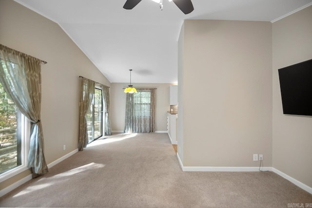 unfurnished room featuring vaulted ceiling, light colored carpet, and ceiling fan