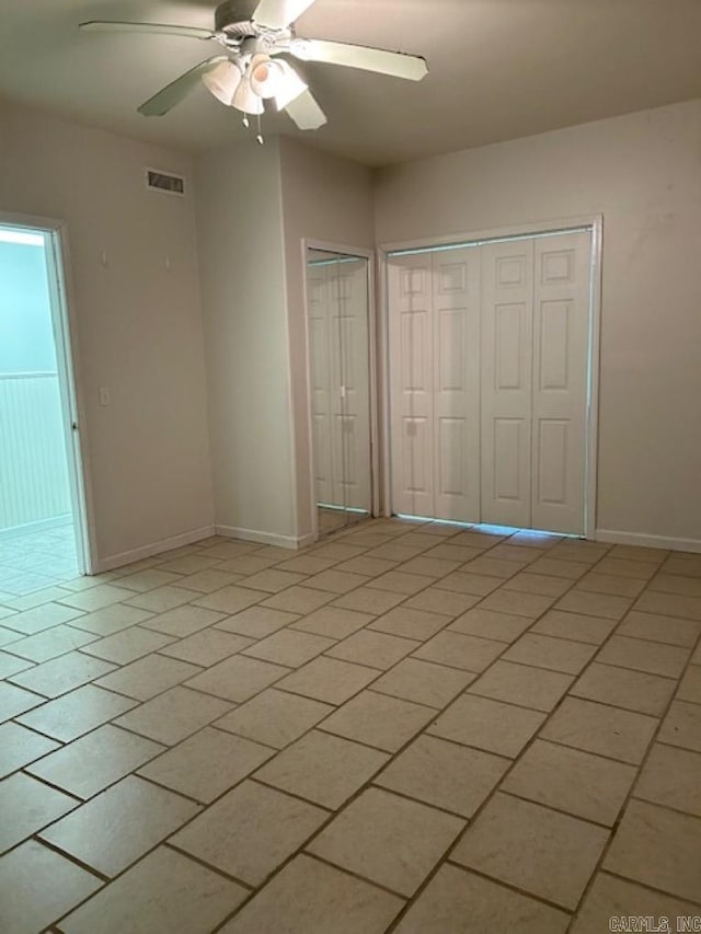 unfurnished bedroom with ceiling fan and light tile patterned floors