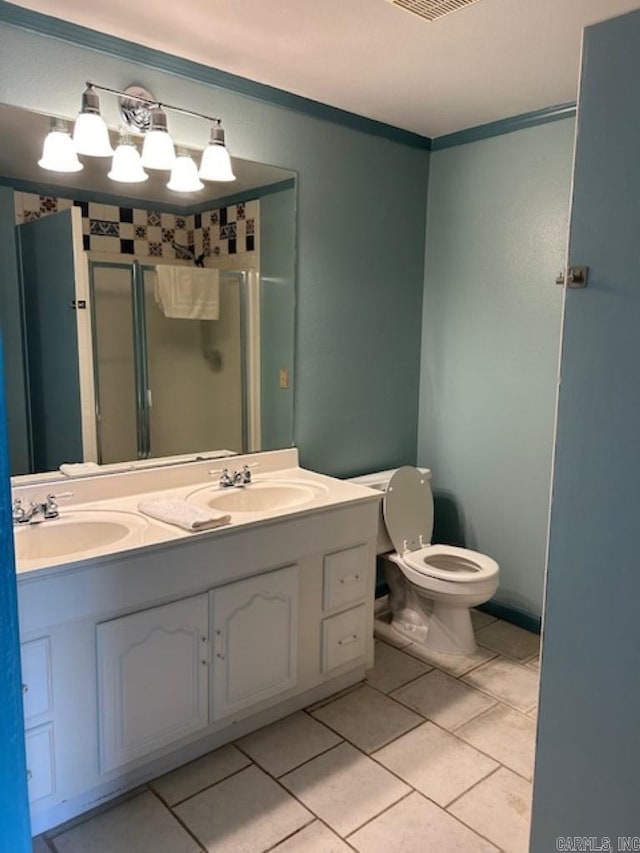 bathroom with toilet, vanity, tile patterned floors, and walk in shower