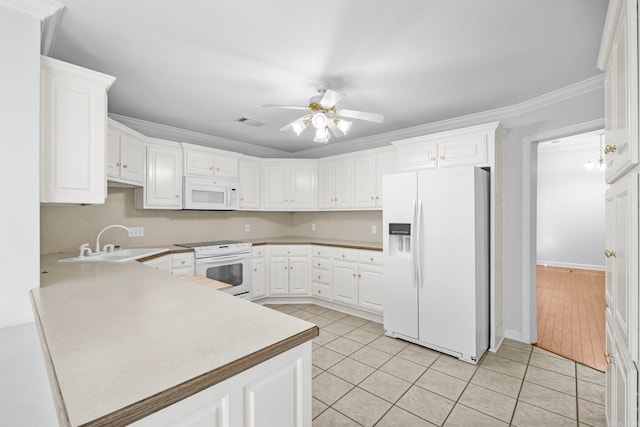 kitchen featuring sink, white cabinets, crown molding, and white appliances