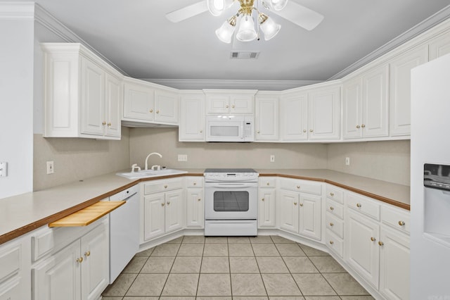 kitchen featuring white appliances, ornamental molding, sink, and white cabinets