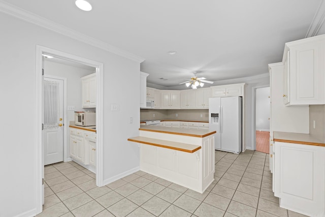 kitchen with crown molding, white cabinetry, light tile patterned floors, and white appliances