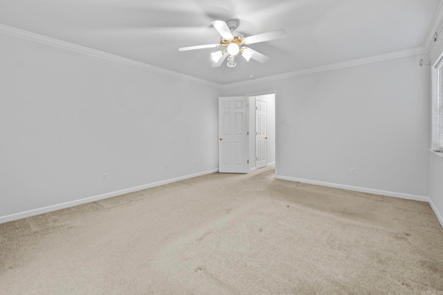 carpeted empty room featuring ornamental molding and ceiling fan