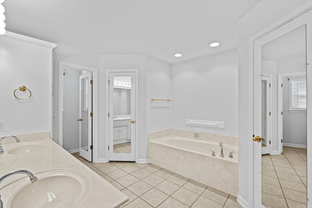 bathroom with vanity, a tub, and tile patterned flooring