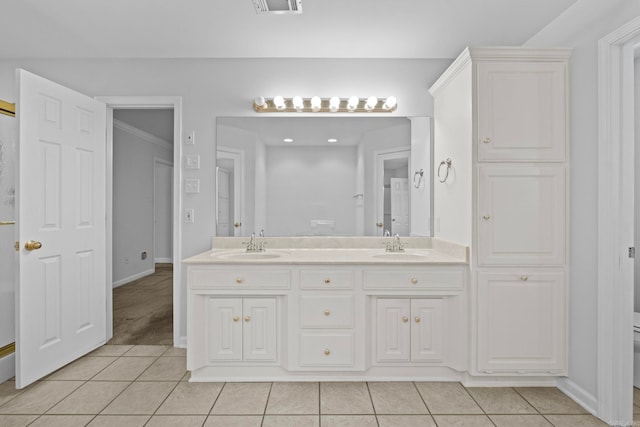 bathroom with vanity, crown molding, and tile patterned floors