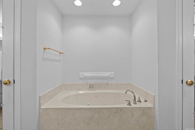 bathroom featuring tiled tub