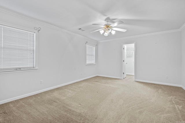 carpeted empty room featuring ceiling fan and ornamental molding