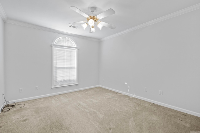 carpeted spare room featuring ornamental molding and ceiling fan