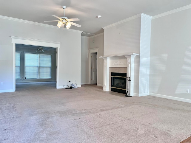 unfurnished living room featuring a tiled fireplace, ceiling fan, carpet flooring, and ornamental molding