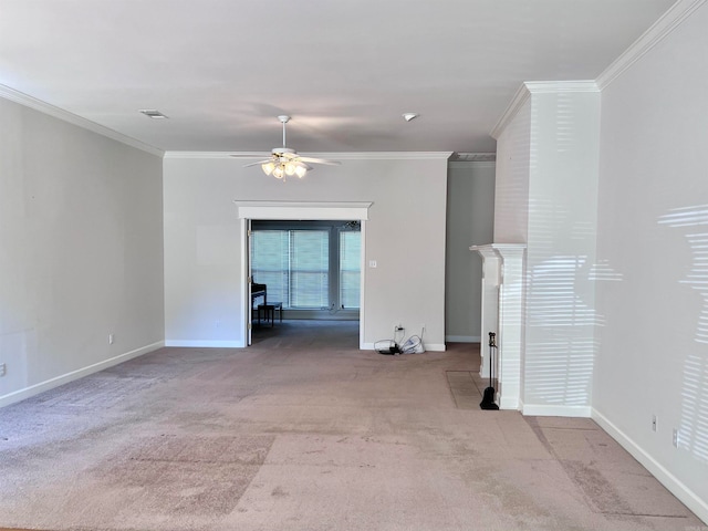 empty room featuring crown molding, light carpet, and ceiling fan