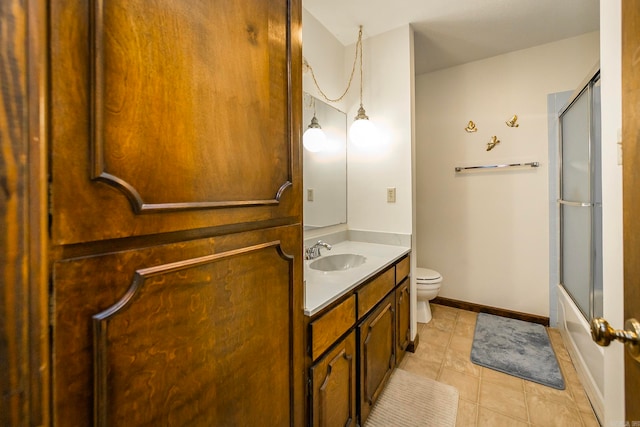 full bathroom featuring vanity, toilet, tile patterned flooring, and bath / shower combo with glass door