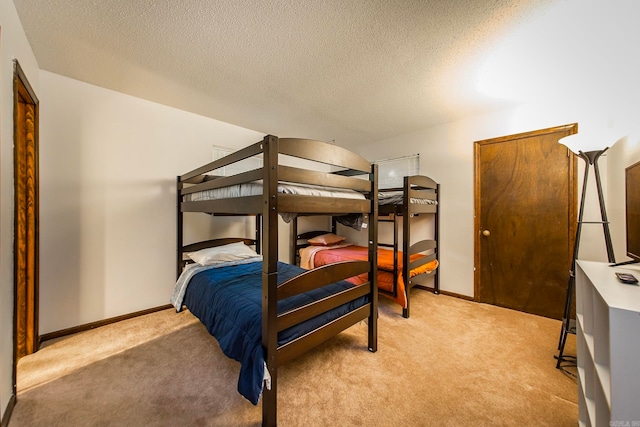 carpeted bedroom featuring a textured ceiling