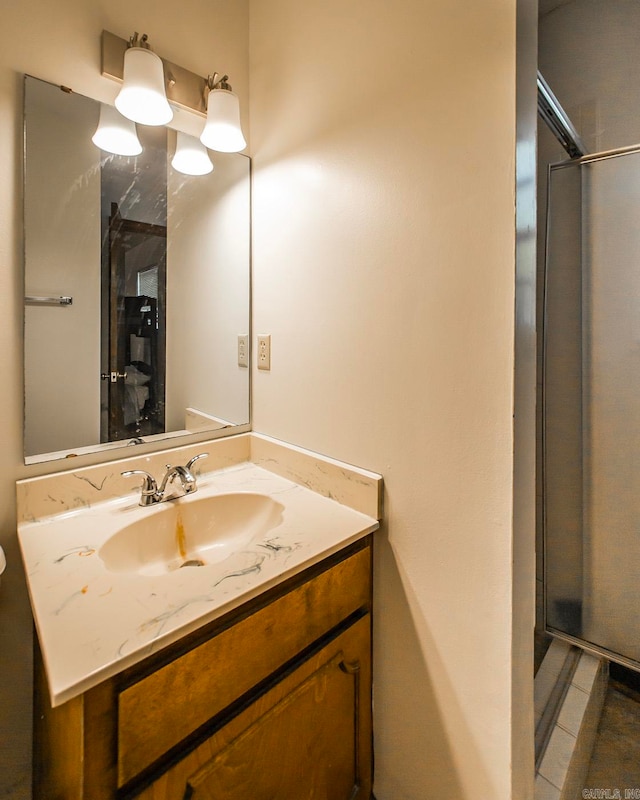 bathroom featuring vanity, tile patterned flooring, and a shower with door