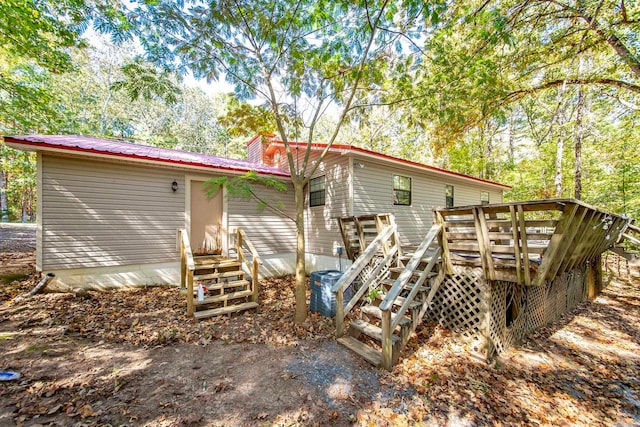 back of property featuring a deck