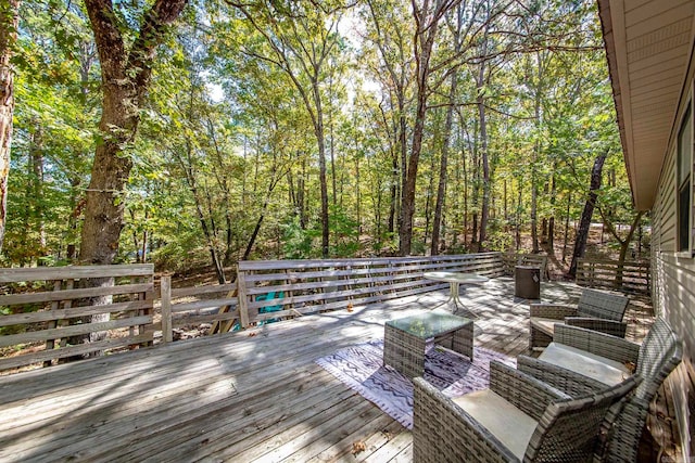 wooden terrace with an outdoor living space