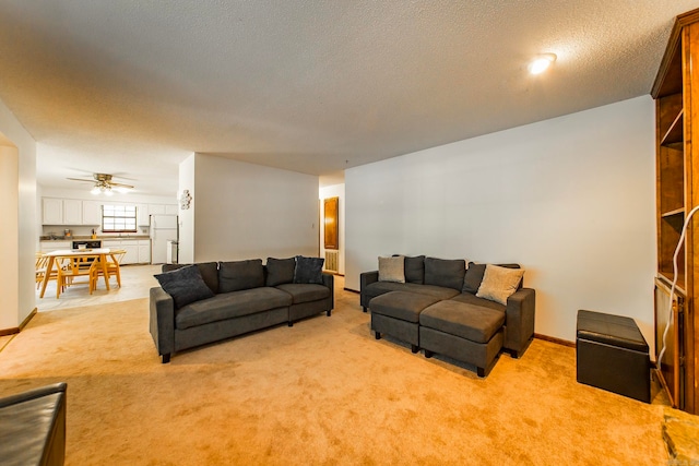 carpeted living room featuring a textured ceiling and ceiling fan