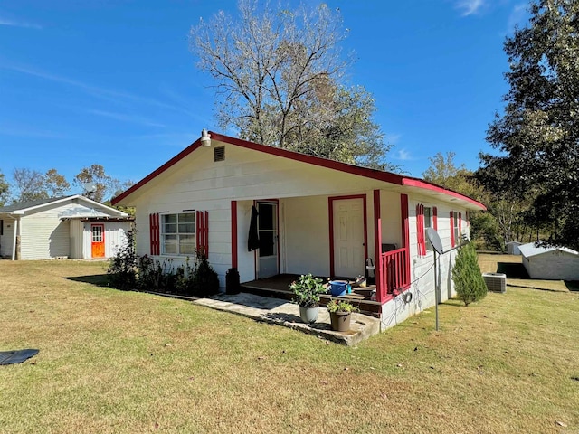 ranch-style home featuring a front yard and central AC unit