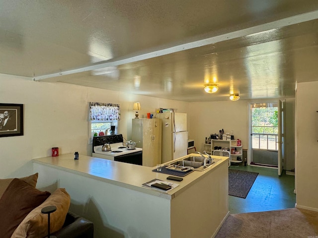 kitchen featuring white appliances, sink, and kitchen peninsula