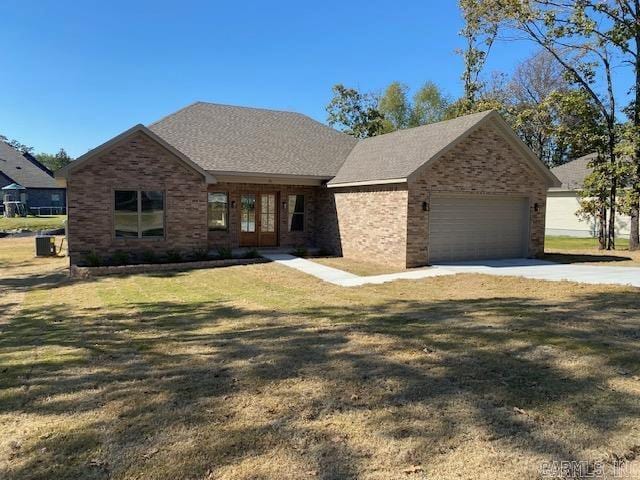 view of front of house with a front yard and a garage