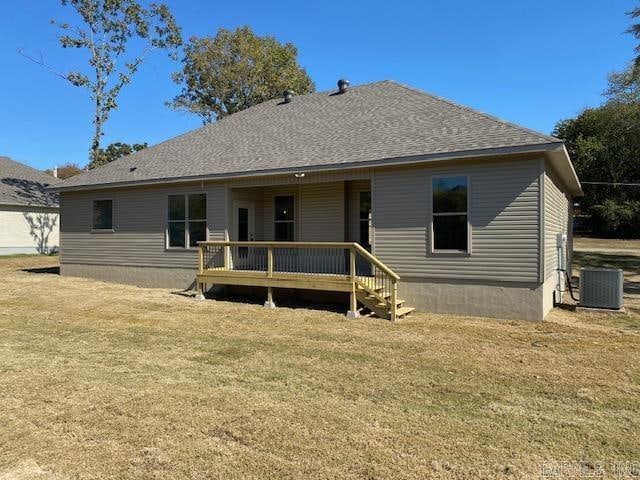 back of house featuring a deck, cooling unit, and a lawn