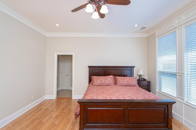 bedroom with crown molding, light hardwood / wood-style flooring, and ceiling fan