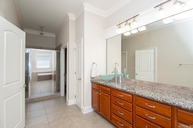 bathroom with vanity, a shower with shower door, ornamental molding, and tile patterned flooring