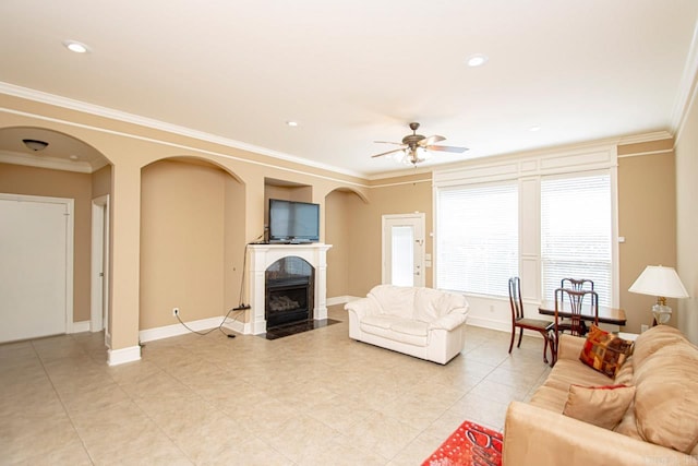 living room featuring crown molding and ceiling fan