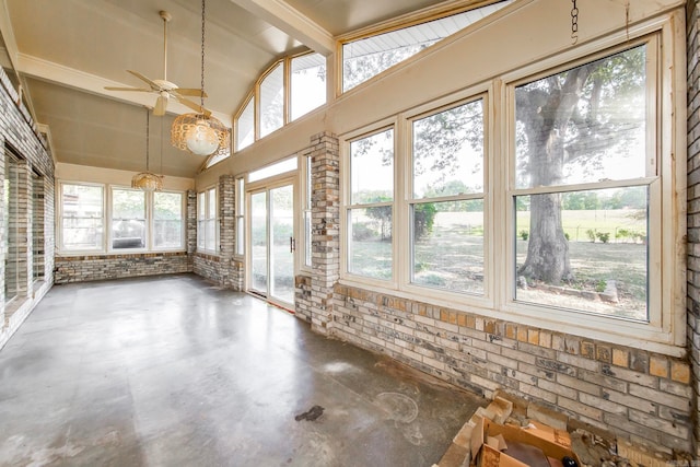 unfurnished sunroom with vaulted ceiling with beams, a healthy amount of sunlight, and ceiling fan