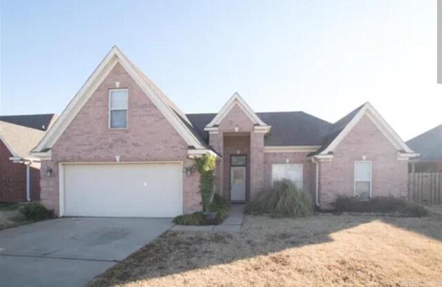 traditional-style house with a garage and concrete driveway