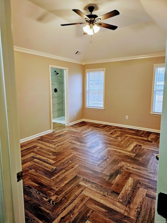 empty room featuring ornamental molding, a wealth of natural light, ceiling fan, and baseboards