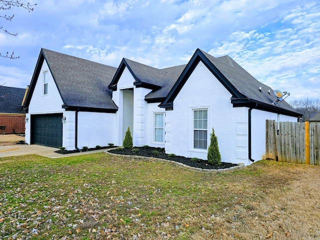 view of front of home featuring brick siding, roof with shingles, a front yard, and fence