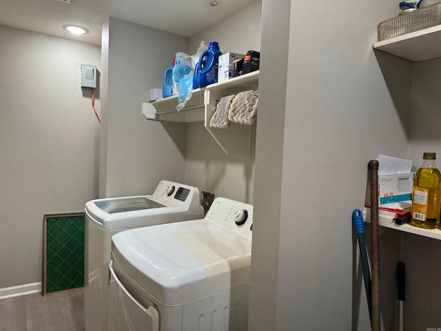 clothes washing area featuring separate washer and dryer and light wood-type flooring