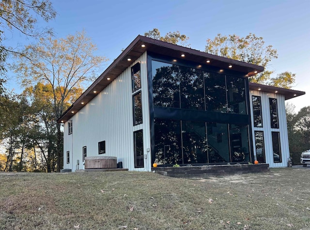 view of side of home featuring a sunroom