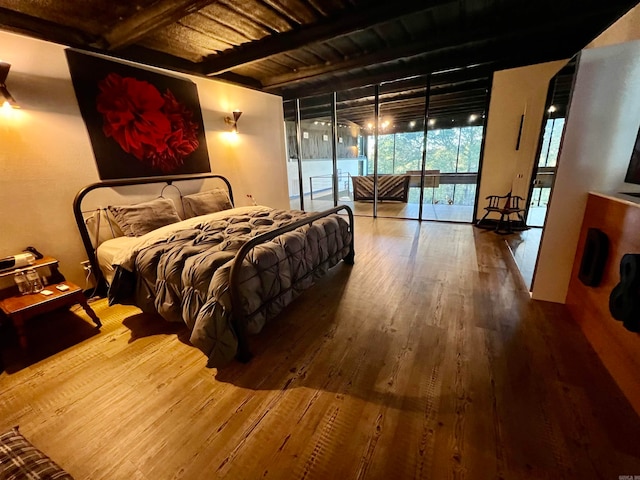 bedroom featuring access to outside, hardwood / wood-style flooring, beamed ceiling, and wood ceiling