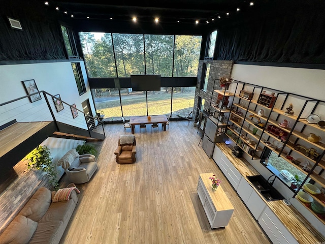 interior space featuring a high ceiling and hardwood / wood-style flooring