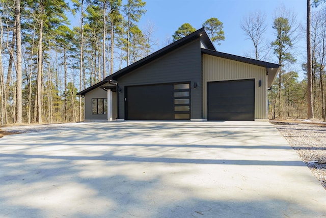 garage featuring concrete driveway