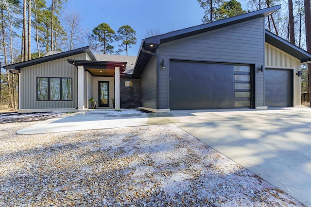 view of front of home featuring brick siding, driveway, and an attached garage