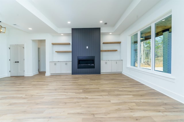 unfurnished living room with light wood-style flooring, baseboards, and recessed lighting