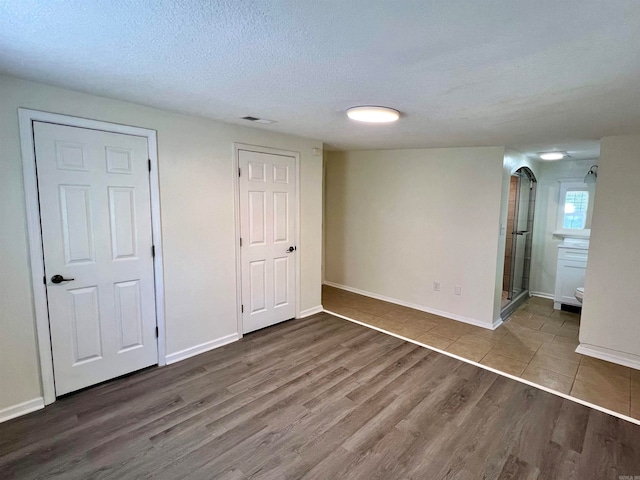 interior space featuring a textured ceiling and hardwood / wood-style floors