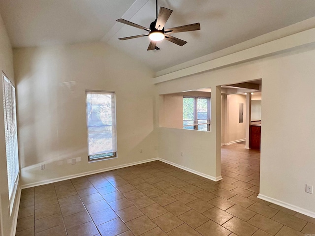 unfurnished room with dark tile patterned flooring, ceiling fan, a healthy amount of sunlight, and lofted ceiling