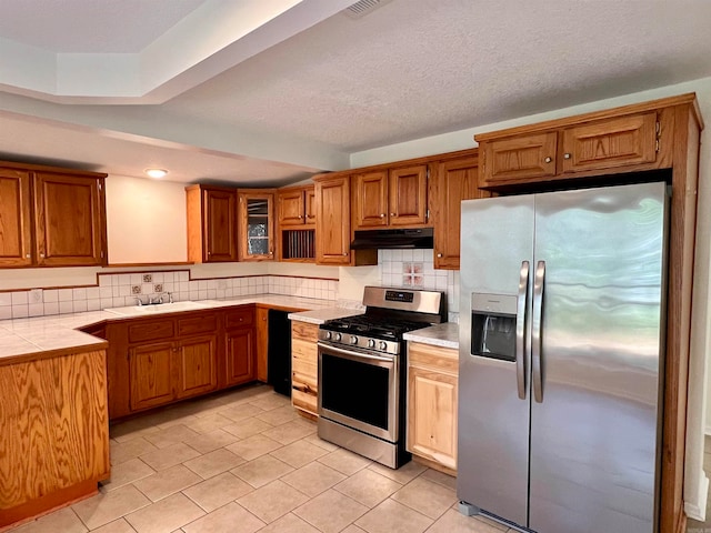 kitchen featuring sink, appliances with stainless steel finishes, and backsplash