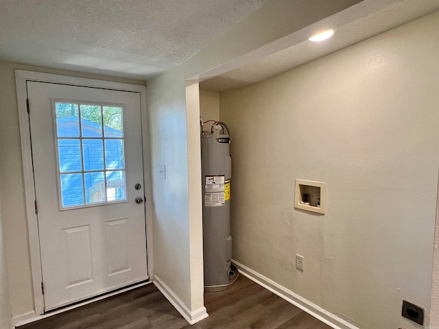 entryway featuring electric water heater, a textured ceiling, and dark hardwood / wood-style floors